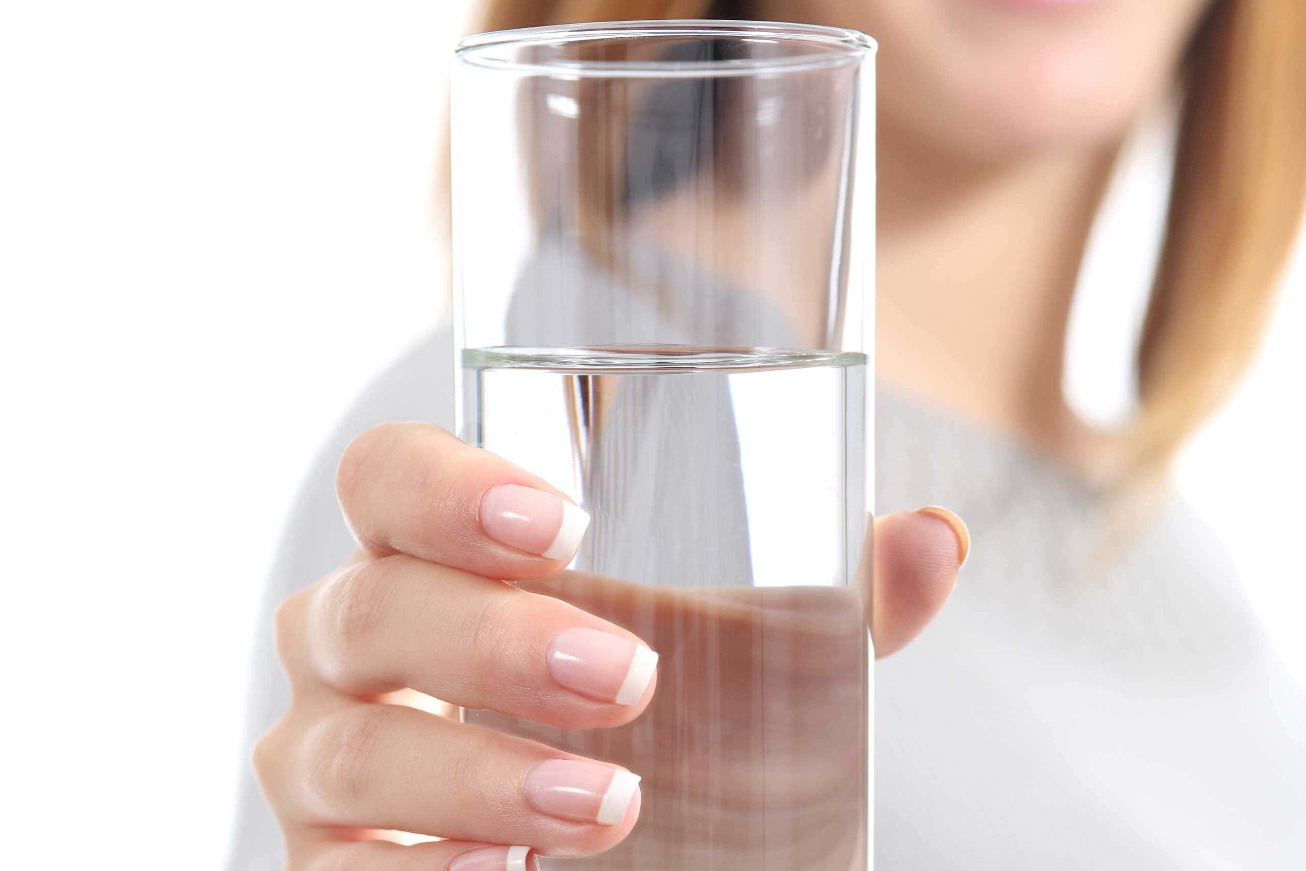 Woman holding up glass of water